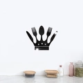 Macro detail of black acrylic mirror crown wall sticker with cutlery and star cutouts - Black