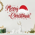 Detail of Merry Christmas wall decal with Santa hat on a white living room wall - Red Script Style (PH_QTB59)