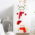 Detail of Christmas snowman stickers with red scarves and hats on a white refrigerator surface - Double Snowman Decoration (PH_QTX40)