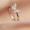 Macro view of silver butterfly ring on pink silk fabric showing intricate cutout wings - 3D Butterfly Ring (DZ-823)