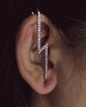 Rose gold lightning bolt ear crawler with zircon stones on female model's ear - Lightning Style Rose Gold (WG0-0317)