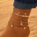 Detail of layered gold anklet set with star and pearl charms on sandy beach - Gold Pineapple Rhinestone Pearl (7835)