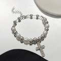 Close-up of baroque pearl bracelet with sparkling crystal cross charm and mirror reflection - Rhinestone Cross Pendant Style / White K (0313)