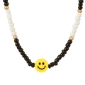 Minimalist handcrafted beaded necklace with black, white, and a yellow smiley face bead - Black And White Beads Smiley Style