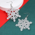 Festive silver glitter snowflake drop earrings on a Christmas themed background - Glitter Snowflake Earrings (G-587)
