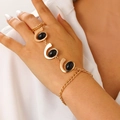 Gold chain finger ring bracelet with three black oval gemstones in a vintage boho style - Gold Black Bead Style (7719)
