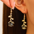 Close-up of vintage black rose drop earrings with gold stem on model's ear - Rose Flower Ear Hook (WG-0359) / Black