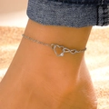 Close-up of infinity symbol and heart anklet with sparkling crystals on the beach - White K Heart Infinity Style (K-1021)