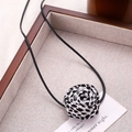 Detail of handmade leopard print fabric rose pendant on a minimalist black cord necklace - Fabric Rose Tie Style / Black and White Leopard Print