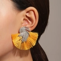 Statement yellow silk tassel fan earrings with textured silver wave stud on model - Yellow