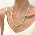 Bohemian colorful clay heart necklace with baroque pearls and gold beads on model - Orange Green