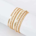 Close-up of golden multi-layer chain bracelet set featuring snake and cuban links - Gold Wide Narrow Herringbone Figaro 6-Piece Set (3522)