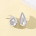 Macro shot of silver teardrop earrings with a high-polished mirror finish and sleek design - Silver