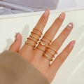 Detail of 12-piece gold-toned stacking ring set with rhinestone accents and feather motifs - 12-Piece Set (X708) / 12pcs Set / KC Gold