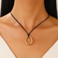 Detail of minimalist gold oval pendant with black cord worn on model neck - Oval Pendant Style (KC Gold)