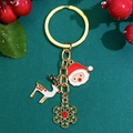 Christmas keychain featuring Santa, reindeer and snowflake pendants on green background - Santa Claus And Snowflake Style (9679) / KC Gold