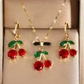Elegant cherry jewelry set with red gemstones and green leaves in golden box - Cherry Jewelry Set (5584) / Necklace + Earrings / 18K Gold