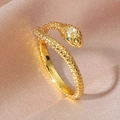 Golden snake ring with cubic zirconia paving and green stone eyes on silk fabric - Imitation Gold