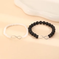 Detail of couple bracelets with black and white beads and silver infinity charms - Black and White Beaded Infinity Symbol (10262)