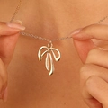 Detail of a polished gold bow pendant necklace on a model showing the elegant O-chain - Gold 3D Bowknot (Thin Chain)