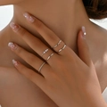 Five-piece silver knuckle ring set with faux pearls and twisted rope bands on a hand - 5-Piece Set (DZ-366) / Five-Piece Set / White Gold