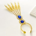 Gold ethnic slave bracelet with blue gemstones and five hollow-out filigree finger rings - Blue