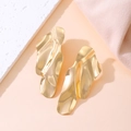 Detail of gold irregular wavy earrings with a high-polished metallic finish and fluid design - Medium KC Gold Color (N-451)