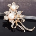 Elegant gold flower brooch with white pearls and sparkling rhinestones on dark base - Pearl Flower
