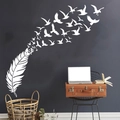 Vinilo decorativo blanco de plumas que se convierten en aves sobre una pared azul oscuro - Blanco