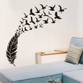 Vinilo decorativo de pluma negra que se transforma en pájaros volando sobre una pared blanca - Negro