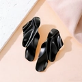Modern abstract wavy earrings in matte black finish on aesthetic textured background - Gunmetal
