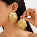 Modern oversized oval gold metal stud earrings with vertical texture on model - KC Gold Color (12391)