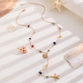 Detail of gold Y-necklace with colorful stone beads, shell and starfish charms - 05 KC Gold Ocean Pendant Style (0560)