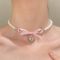 Pink silk bow pearl necklace with silver heart pendant worn on woman's neckline - Polished Heart Style / White Gold