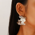Macro shot of silver metal flower earrings with detailed brushed texture on the petals - Double Layer Flower Earrings (9833) / KC Gold