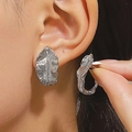 Silver leaf earrings with detailed veins and vintage metallic texture on model - Carved Leaf Vein Ear Buckle (3376) / Silver
