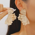 Vintage gold ginkgo leaf stud earrings with brushed metallic texture worn by a model - Layered Ginkgo Leaf Pleated Style (kc Gold A-741) / Gold