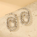 Silver geometric hollow hoop earrings with textured spiral design and sparkling finish - Wavy Oval Style (X706)