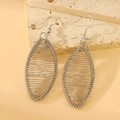 Silver hollow geometric wire earrings with elegant hook design on stone background - Oval Woven Style (K-290)
