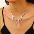 Y2K liquid metal heart necklace with red rhinestone and pearl tassel on model - Silver Style (Red Stone)