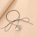 Black cord necklace featuring a polished silver 3D heart pendant and bow detail - Silver (Fine Rope)