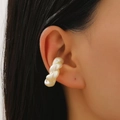 Close-up of a pearlescent twisted ear cuff on the upper ear for non-pierced ears - 21 Pearl White 12350