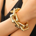 Chunky gold-plated chain link bracelet with polished metallic finish on model - KC Gold Bracelet (Item No. 8301)