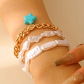 Close-up of three-layer bracelet with gold chain, blue star pendant and white beads - Gold Star Style (8921) / Gold