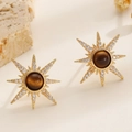 Detail of gold sunburst stud earrings with tiger eye stone and sparkling crystals - Starburst Stud Earrings Style (X143)
