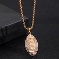 Detailed close-up of hip hop American football pendant necklace with micro-pave crystals - Gold