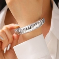 Macro detail of silver wide cuff bracelet featuring unique hammered molten texture - Hammered Texture Bangle (7653) / Bright Silver
