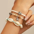Three-piece bohemian beach bracelet set with turtle and starfish charms on a model wrist - Blue Rope Ocean Multi-layer (46 Blue Rope DZ-331)