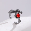 Macro detail of gothic claw ring in dark steel finish with a deep red gemstone - Raven Claw Bead Style (7517)