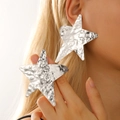 Chunky silver star stud earrings with hammered texture finish worn by female model - Silver Large Hammered Star Style (DZ-794)